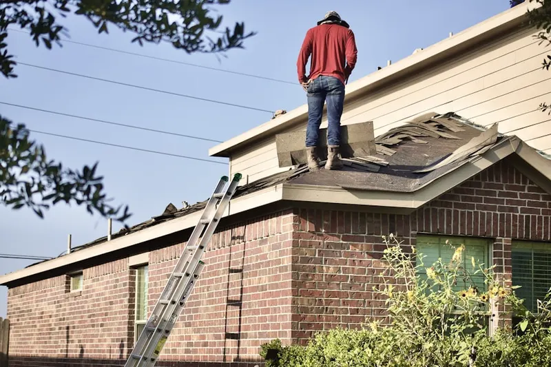 Professional roofer working on a residential roof in Scipio Center